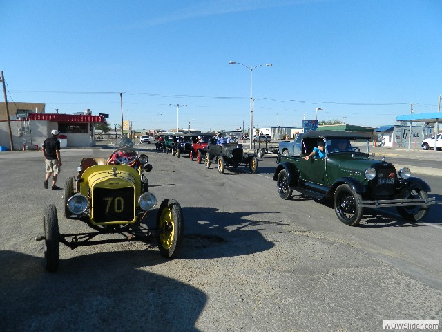 Vern Harvey in his 1923 speedster with Jerry and Vicky Harris in their Model A pickup truck