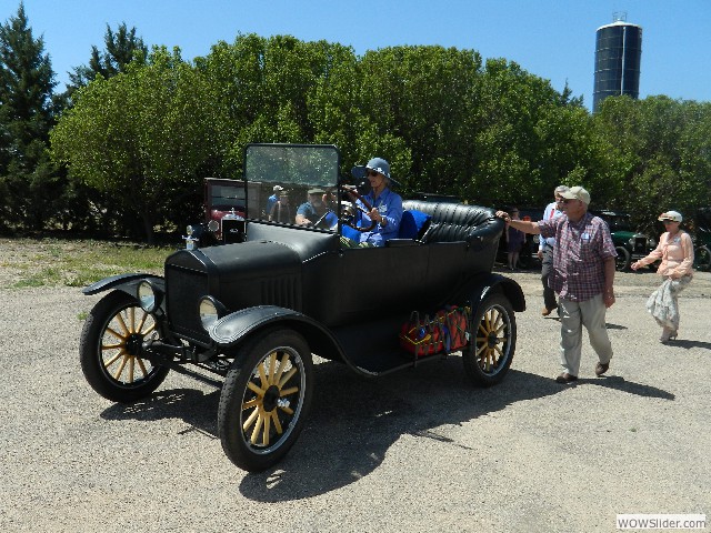 Marilyn in her 1920 Model T touring car getting a helping hand into the Senior Center parking lot