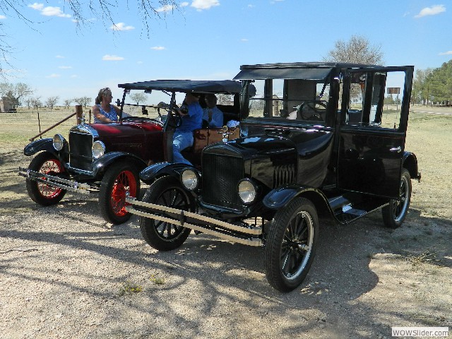 The Petersons's in their 1927 touring car with the Wing's 1924 Model T coupe on the right