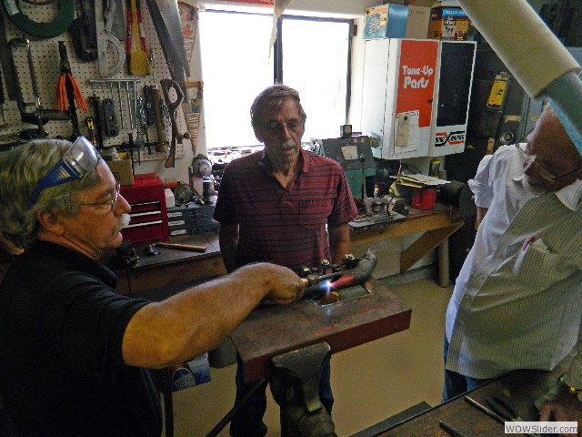 Larry heating the exhaust manifold to bend it back into shape