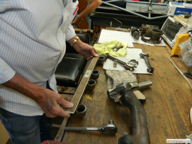 Dean checking straightness of exhaust ports on manifold