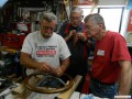 Larry, Bob, and Dave examine Paul's steering wheel 