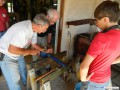 Larry, Don, and Cole focusing on salvaging a rear axle tube.