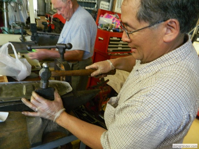 Mark flattening a 1925 touring car inspection plate.