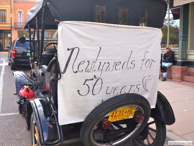 Neil and Mary Anne's touring with sign announcing their wedding anniversary!