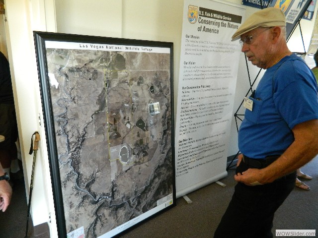 Neil looking over an aerial map of the Wildlife Refuge