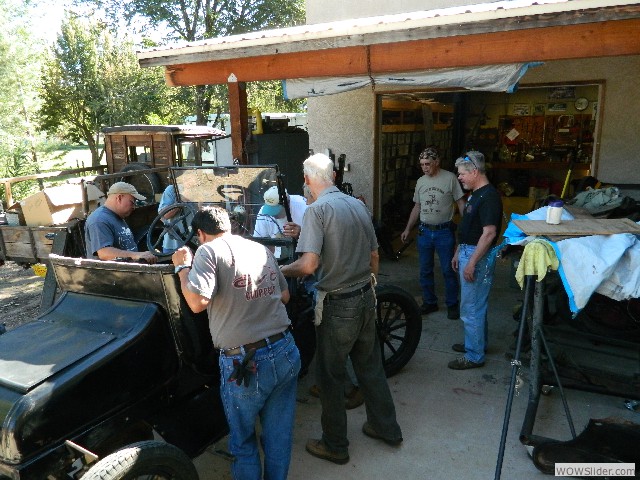 Club members overlooking the take-apart car