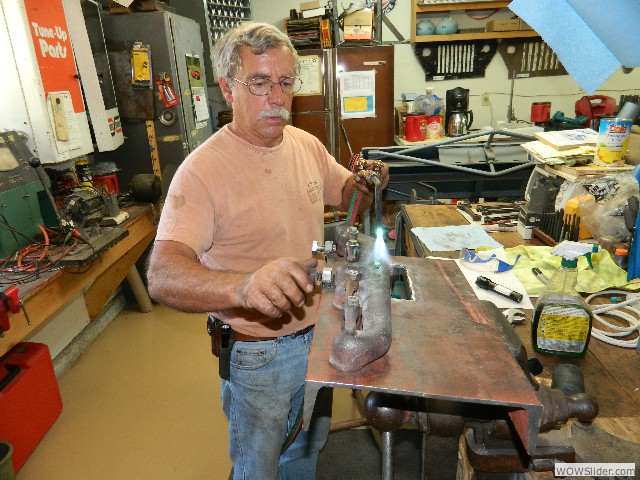 Larry straightening a exhaust manifold for the take-apart car