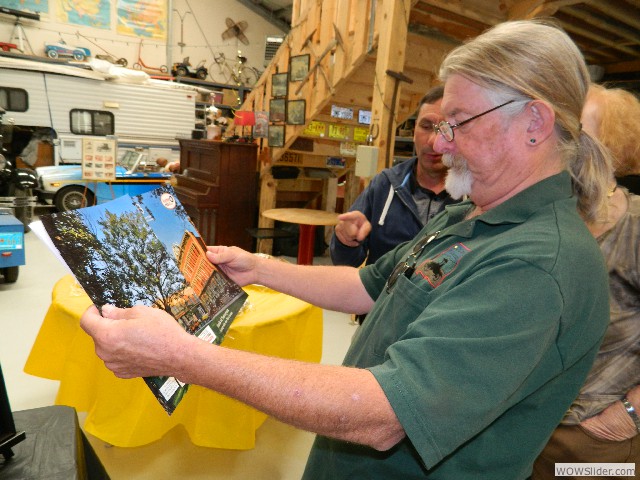 Vaughn looking over the KENW program guide