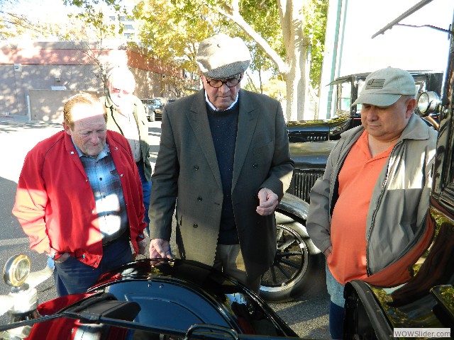 Bob, Dave, Steve, and Bob looking at 1925 engine