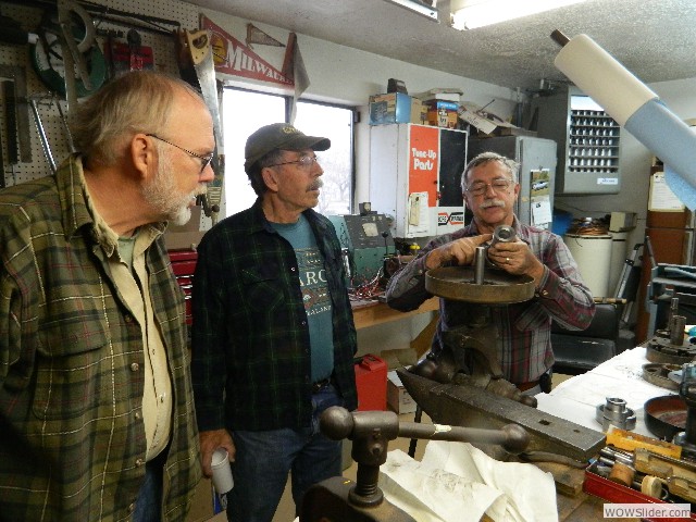 Larry showing Dave and Gerald his floating hub system.