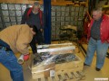 Mark wrapping the engine in plastic with Bob and Tom observing the progress.