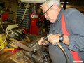 Bob chiseling off rivets on some running board brackets.