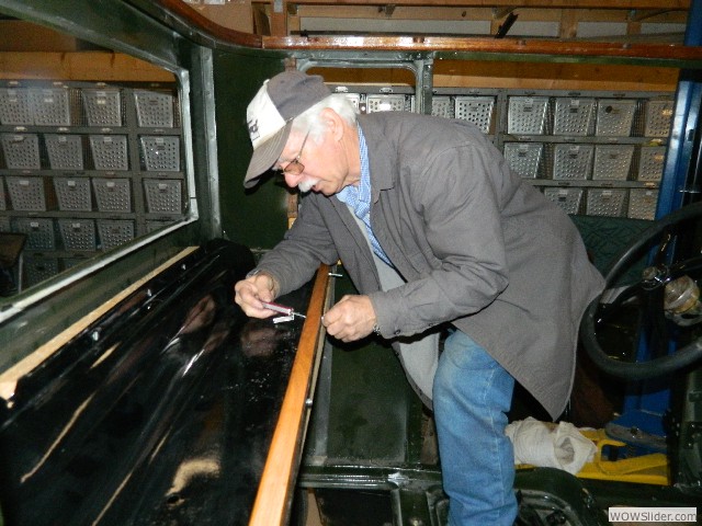 Ken installing a wood strip to the rear window shelf