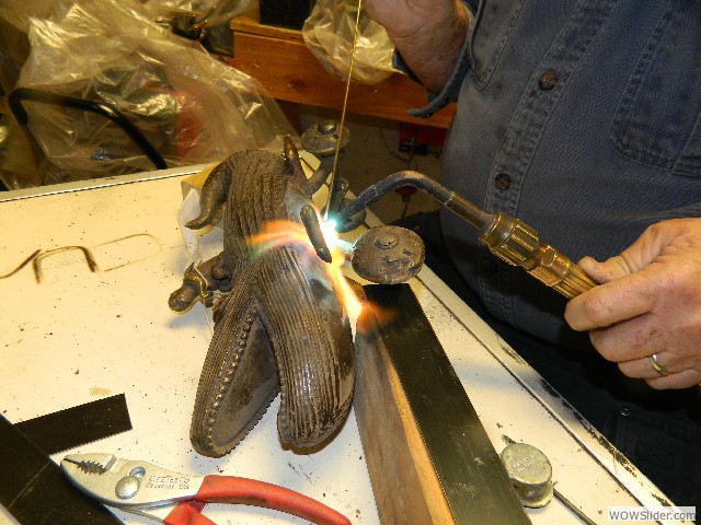 Bob repairing a bronze East Indian alligator toy