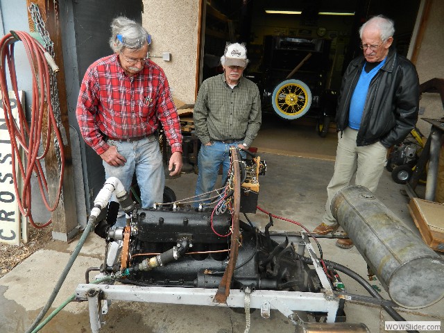 Larry, Ken, and Don listening to Dave's engine