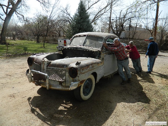 Larry and other club members loading a 1941 Mercury  coupe onto a trailer.