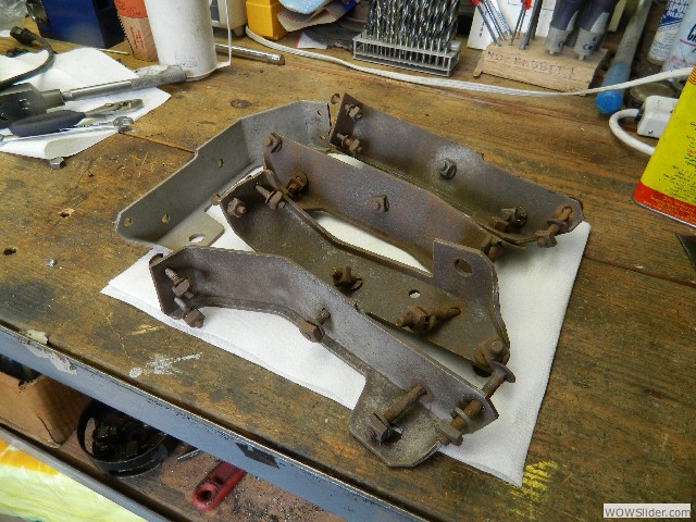 Body brackets being cleaned and rusted bolts removed.