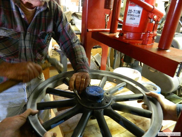 Rotating the hub to align with the spoke holes.