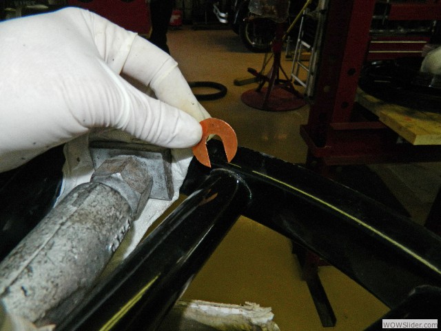 A thin copper shim to tighten the spoke