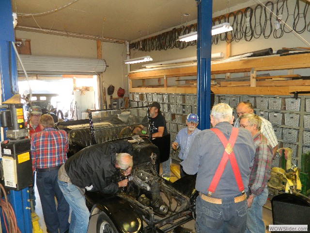 The gang hovering around Bob's roadster