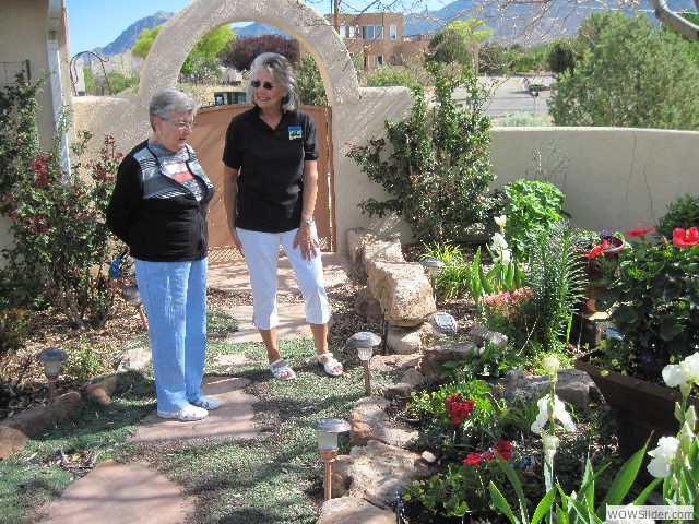 Mary Ann showing Betty her garden in bloom