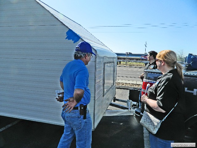 Mark and Sharon showing Larry a damaged area on their trailer
